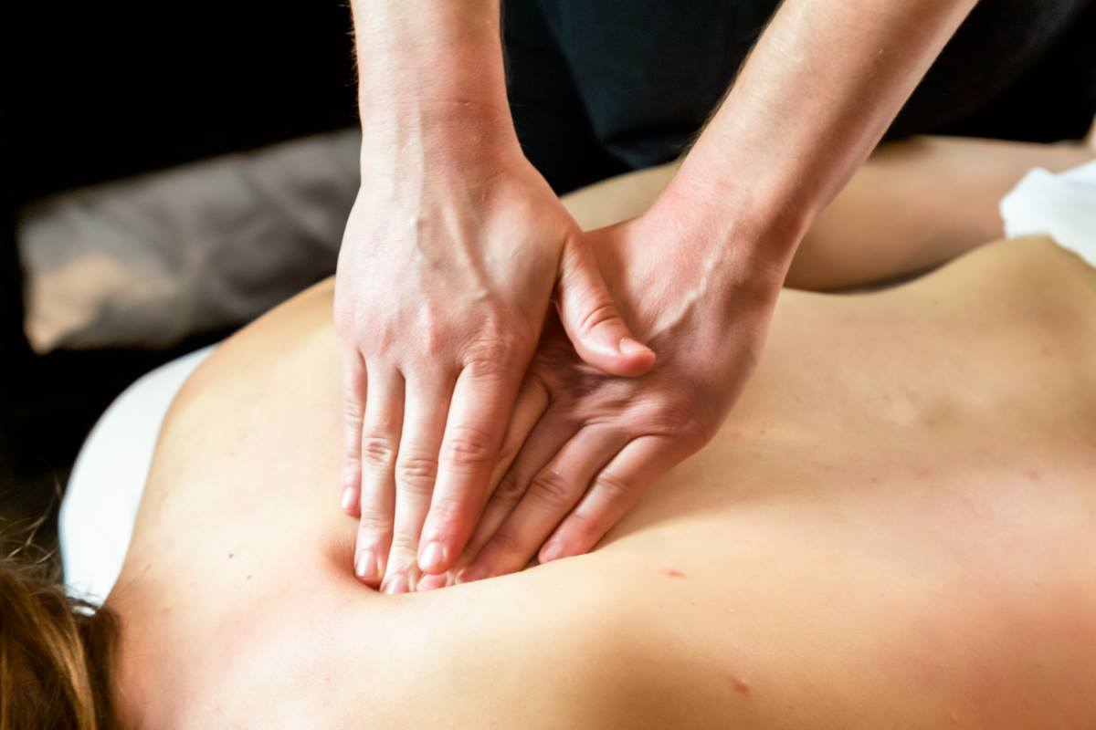 Barefoot woman in sportswear massaging lymphatic nodes on neck with handled  massager while sitting on fitness mat at home, home-based massage and holi  Stock Photo - Alamy